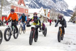 Riders fat biking in Crested Butte in downtown.