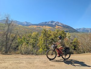 A bikepacker checks out the aspens on the Golden Gravel Trail in Colorado.