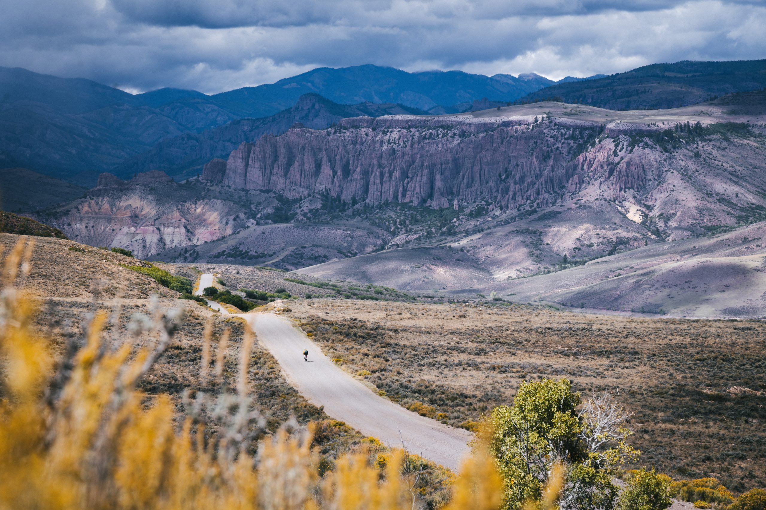 a gravel biker riding down a paved trail