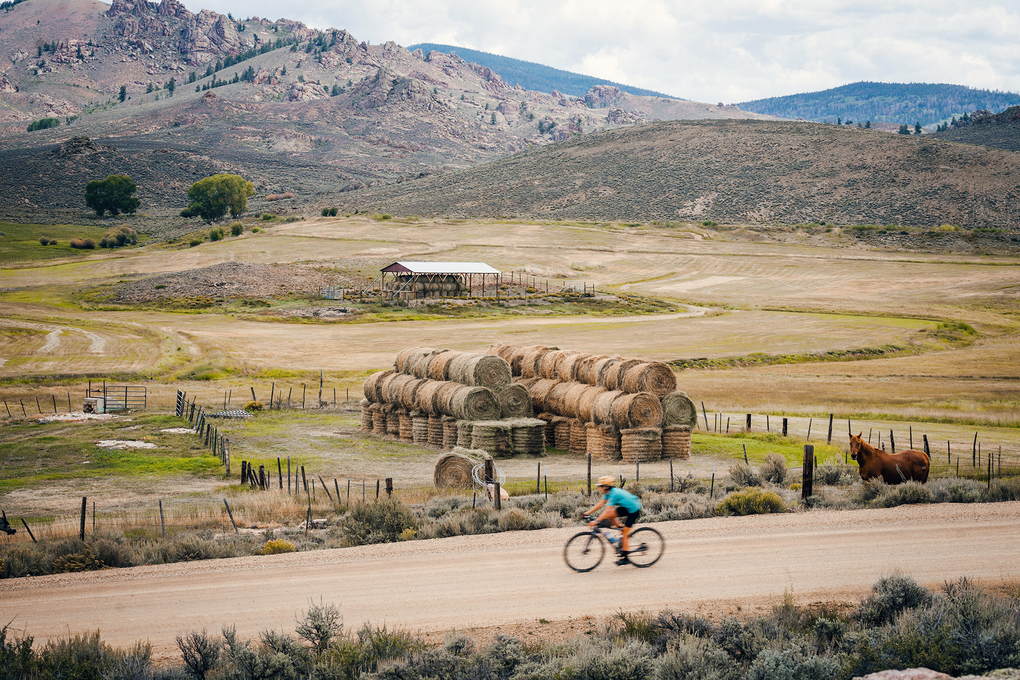 Gravel biking past a hay farm in Gunnison, Colorado in summer