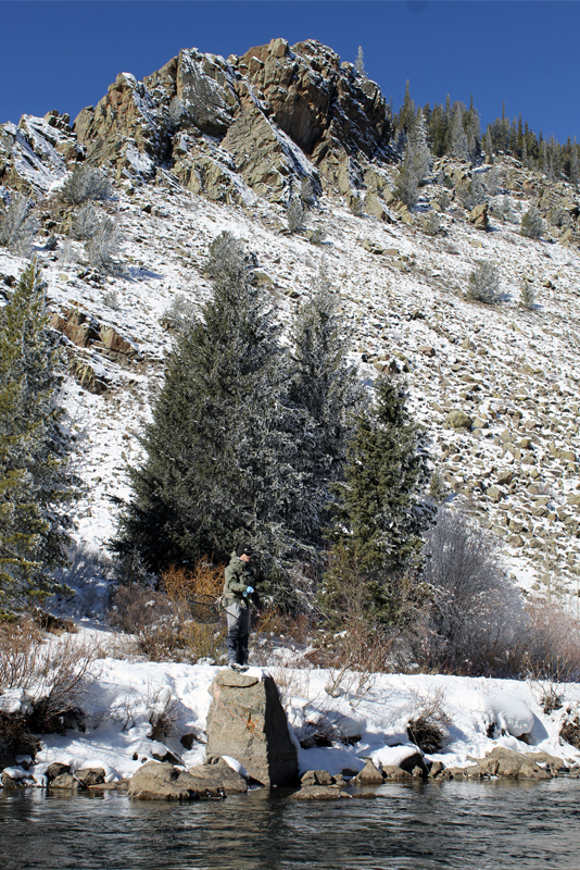 A man fly fishes in winter in the Gunnison area.