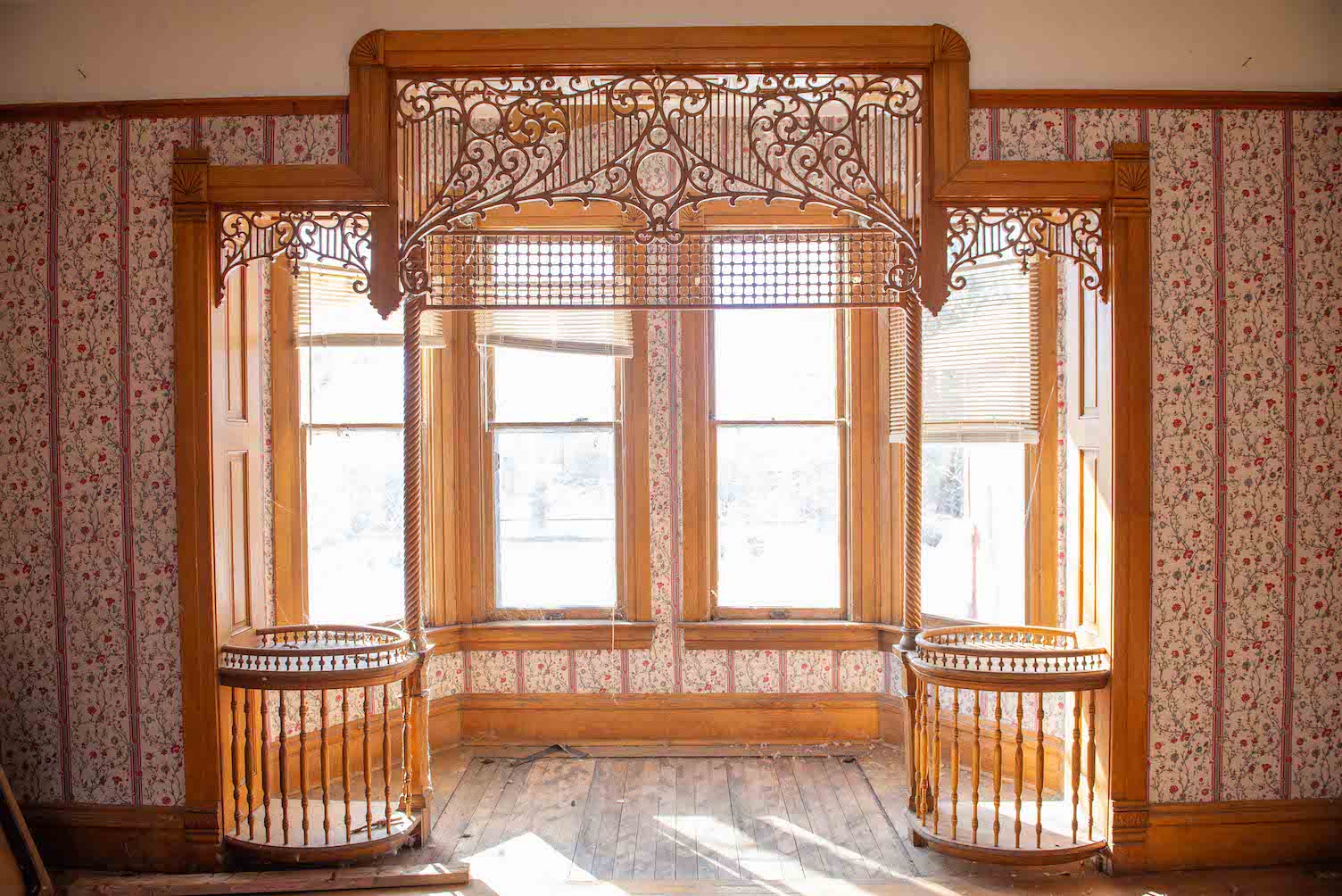 A large window with ornate handmade trim. Hartman Castle is a historic home in Gunnison, CO