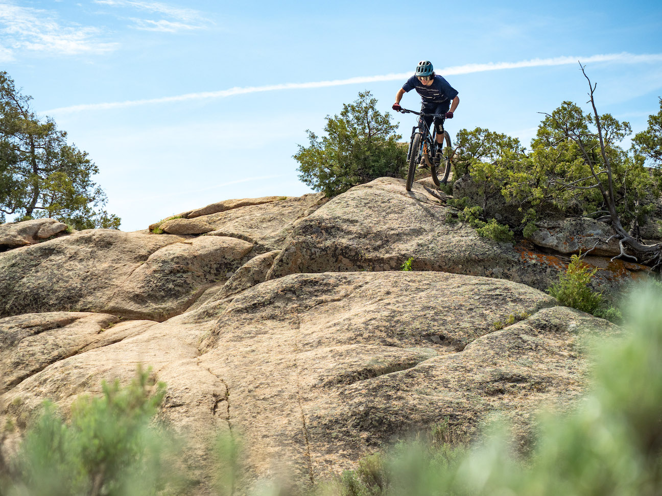 A person riding a bike on a rocky slope at Hartman Rocks Gunnison
