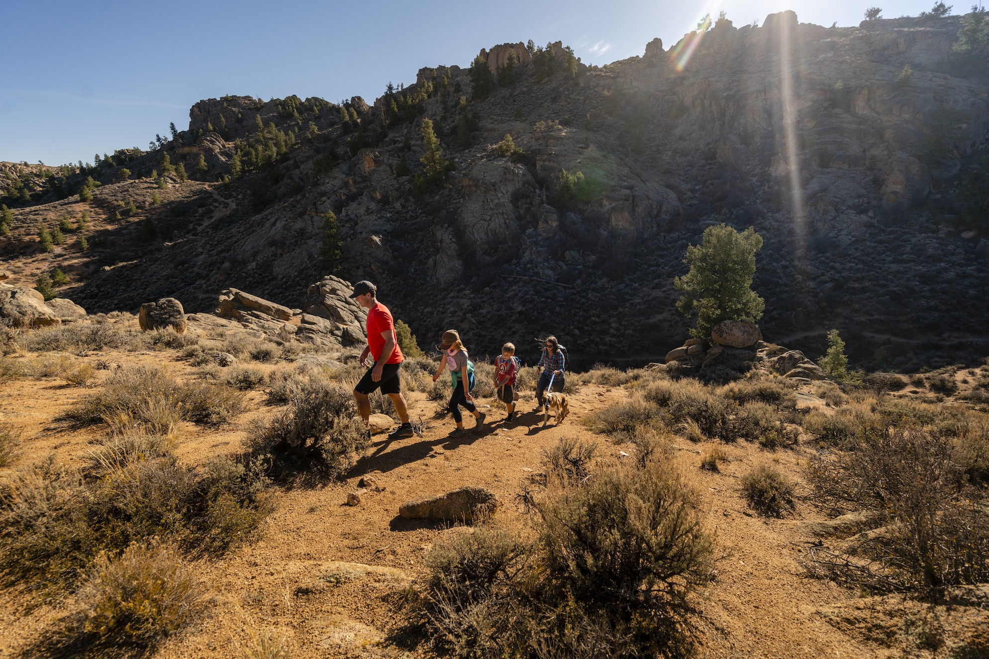 Four people hike in a rocky area 