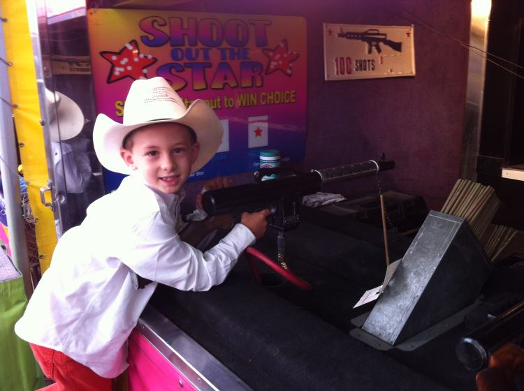 Kid playing Carnival Game at the rodeo in Gunnison, Colorado