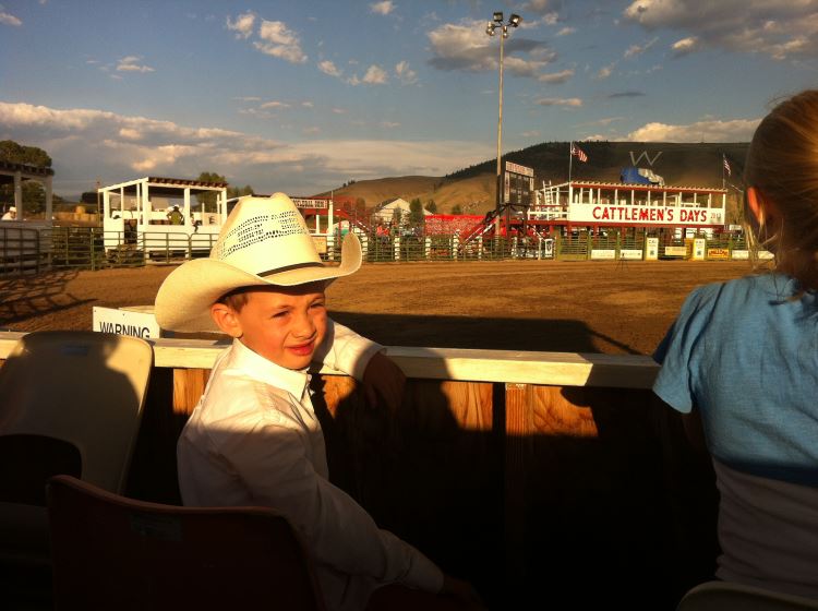 Kid sitting in VIP box at the rodeo