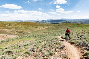 A mountain biker rests on Chicken Wing trail in the Signal Peak trail system.