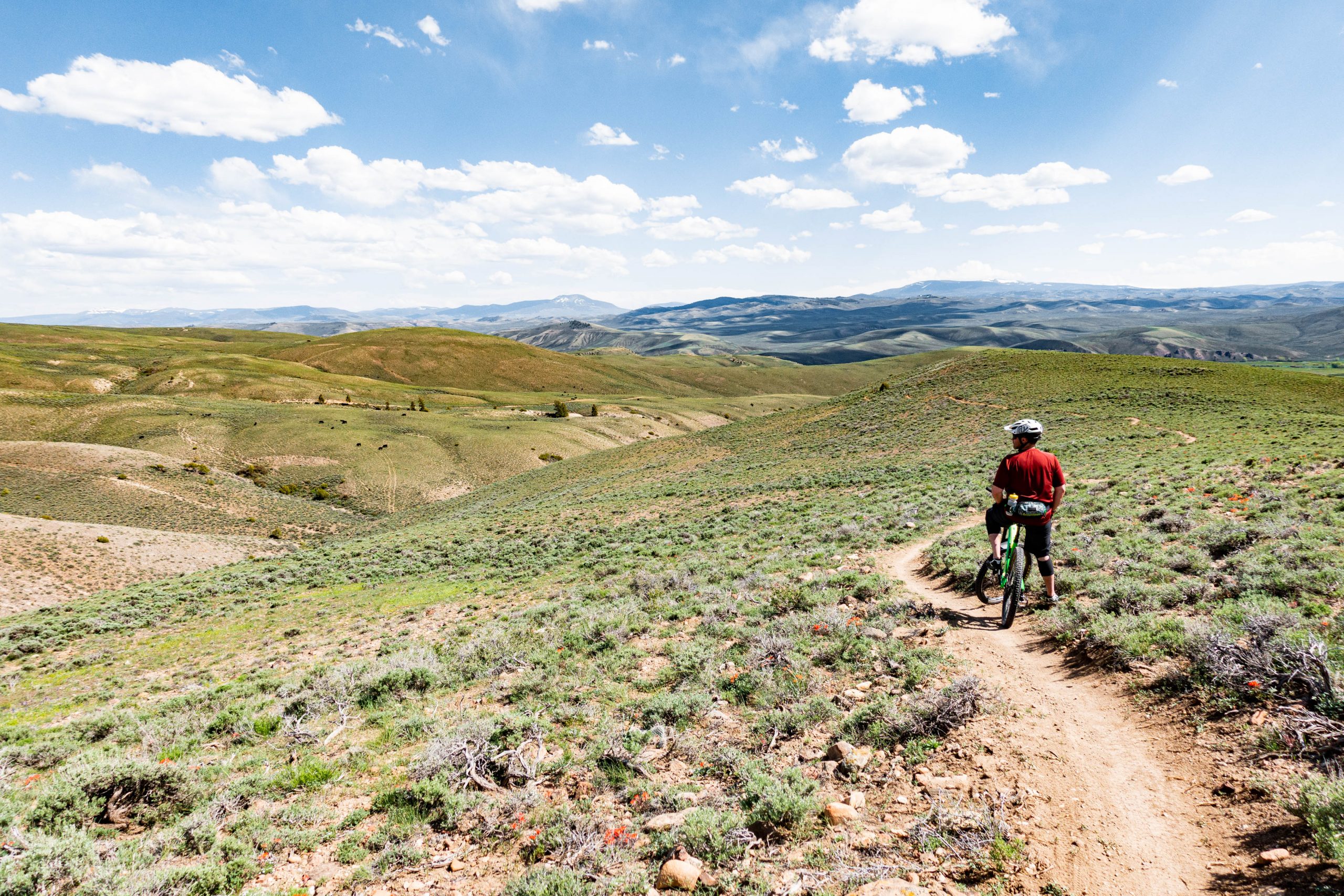 A mountain biker takes a break on the top of a ridge on the Signal Peak trails near Gunnison, Colorado.