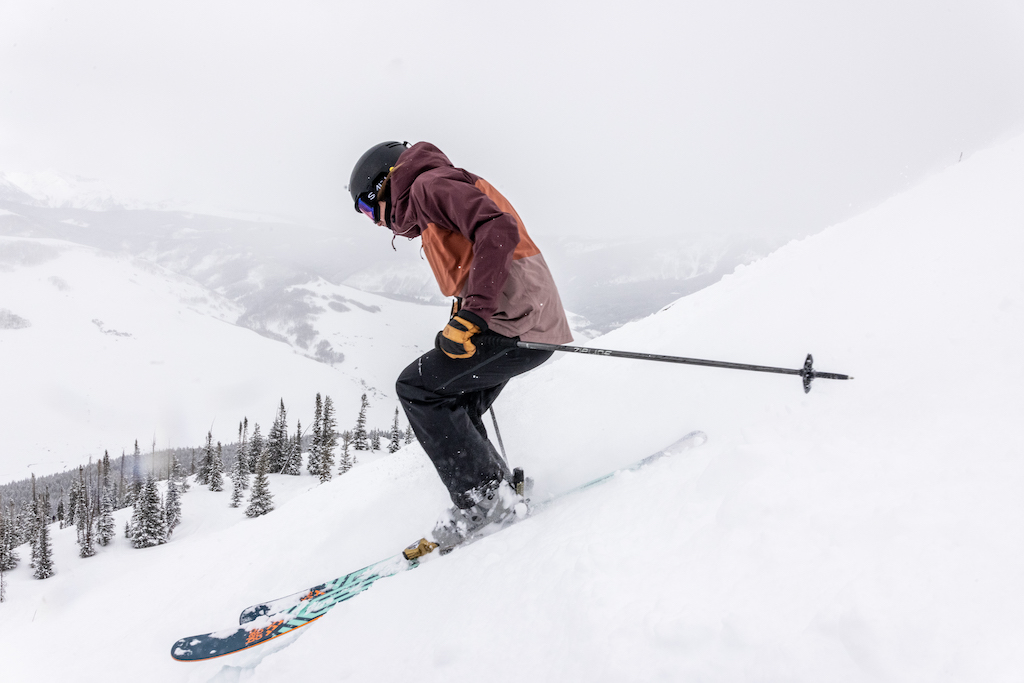 A downhill skier on a snowy hill