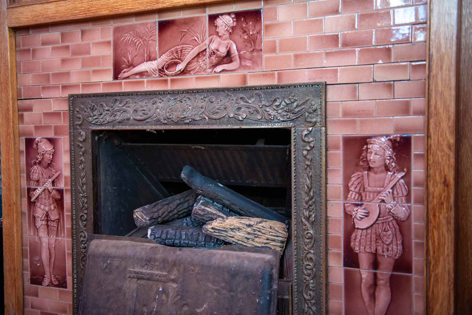 A decorative tiled fireplace in Hartman Castle