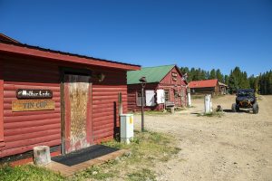 Historic red buildings in Tin Cup, CO in summer.