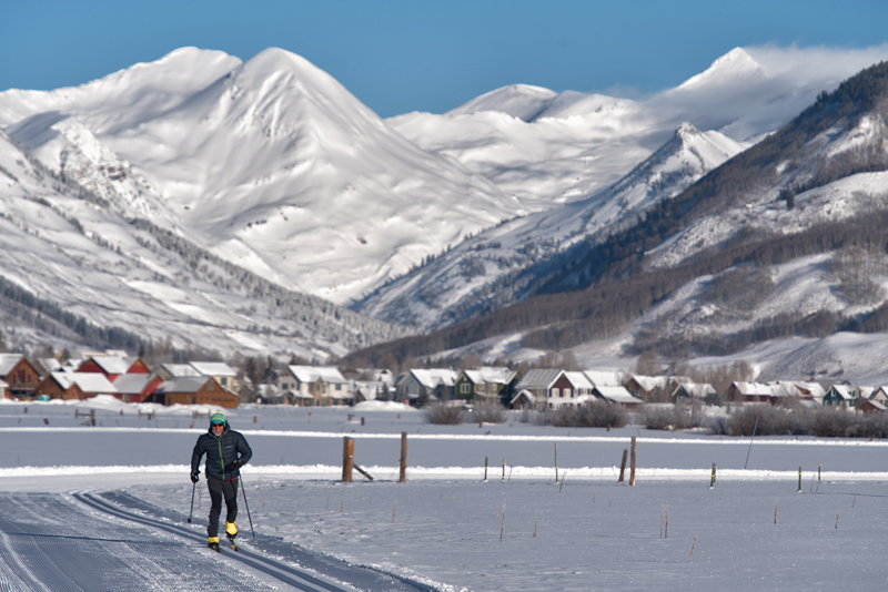 Photo of a nordic skier with Crested Butte's mountains in the background.