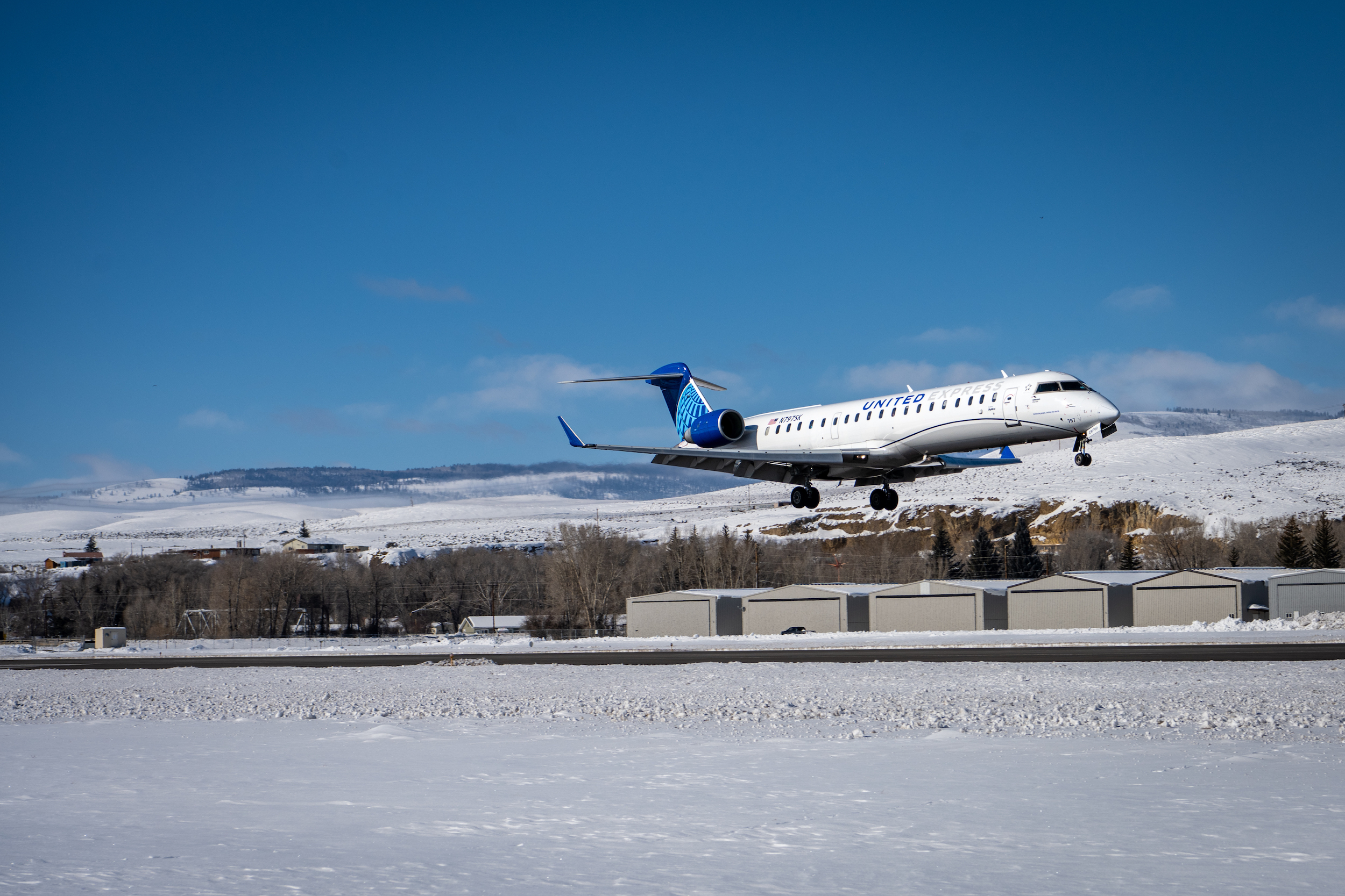 a plane landing on the runway during winter. Get United flights to Gunnison Crested Butte Regional Airport