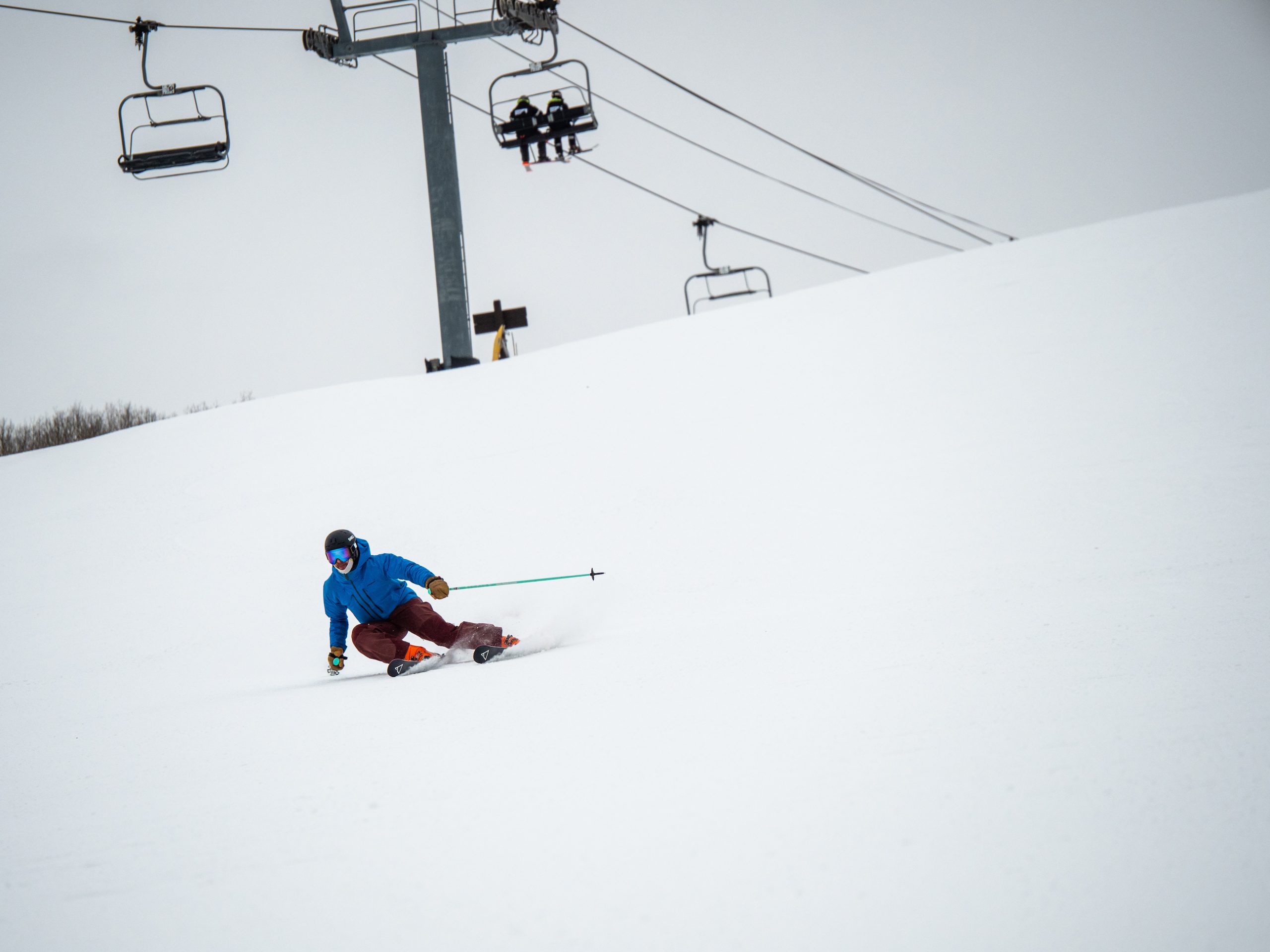 A person skis down a gentle slope called warming house hill at crested butte mountain resort. Warming House Hill heads to the base area 