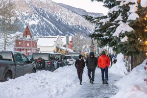 Three people showing what to wear in Crested Butte — casual, warm clothes.