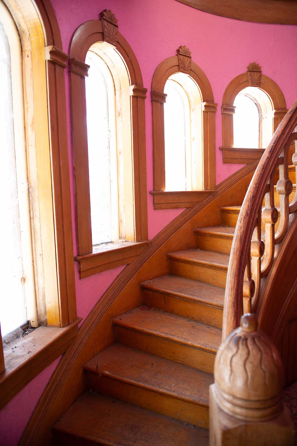 A wooden spiral staircase in Hartman Castle, a historic home in Gunnison, CO